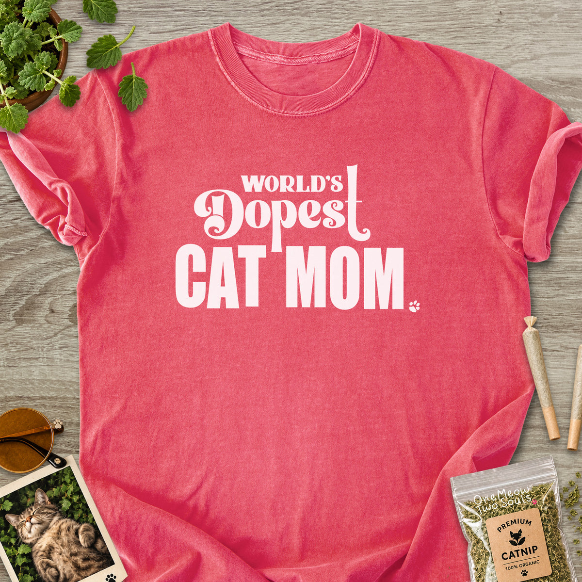 Watermelon colored Comfort Colors 1717 cotton T-shirt, featuring a "World's Dopest Cat Mom" funny cat design illustration. One Meow Two Souls brand.