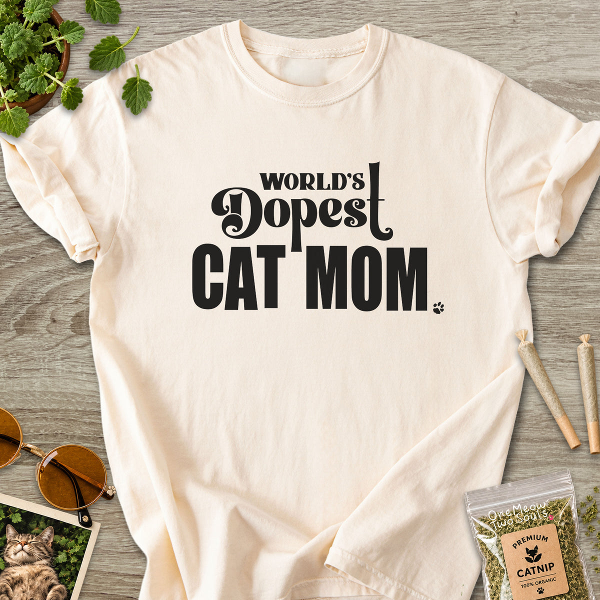 Ivory colored Comfort Colors 1717 cotton T-shirt, featuring a "World's Dopest Cat Mom" funny cat design illustration. One Meow Two Souls brand.