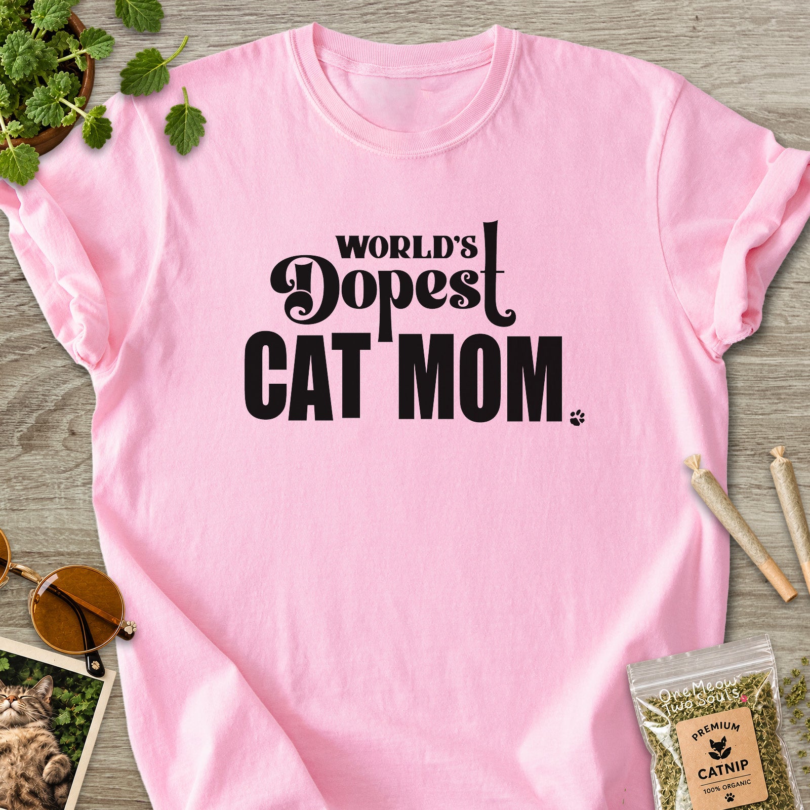 Blossom colored Comfort Colors 1717 cotton T-shirt, featuring a "World's Dopest Cat Mom" funny cat design illustration. One Meow Two Souls brand.