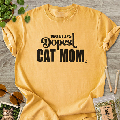 Mustard colored Comfort Colors 1717 cotton T-shirt, featuring a "World's Dopest Cat Mom" funny cat design illustration. One Meow Two Souls brand.