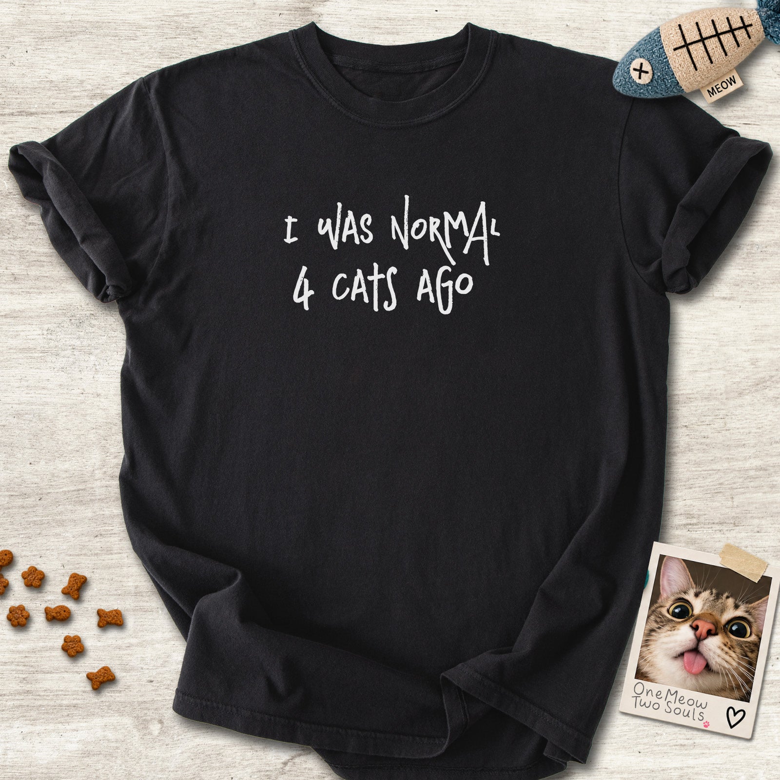 Black colored Comfort Colors 1717 cotton T-shirt, featuring a "I was normal 4 cats ago" funny cat design illustration. One Meow Two Souls brand.