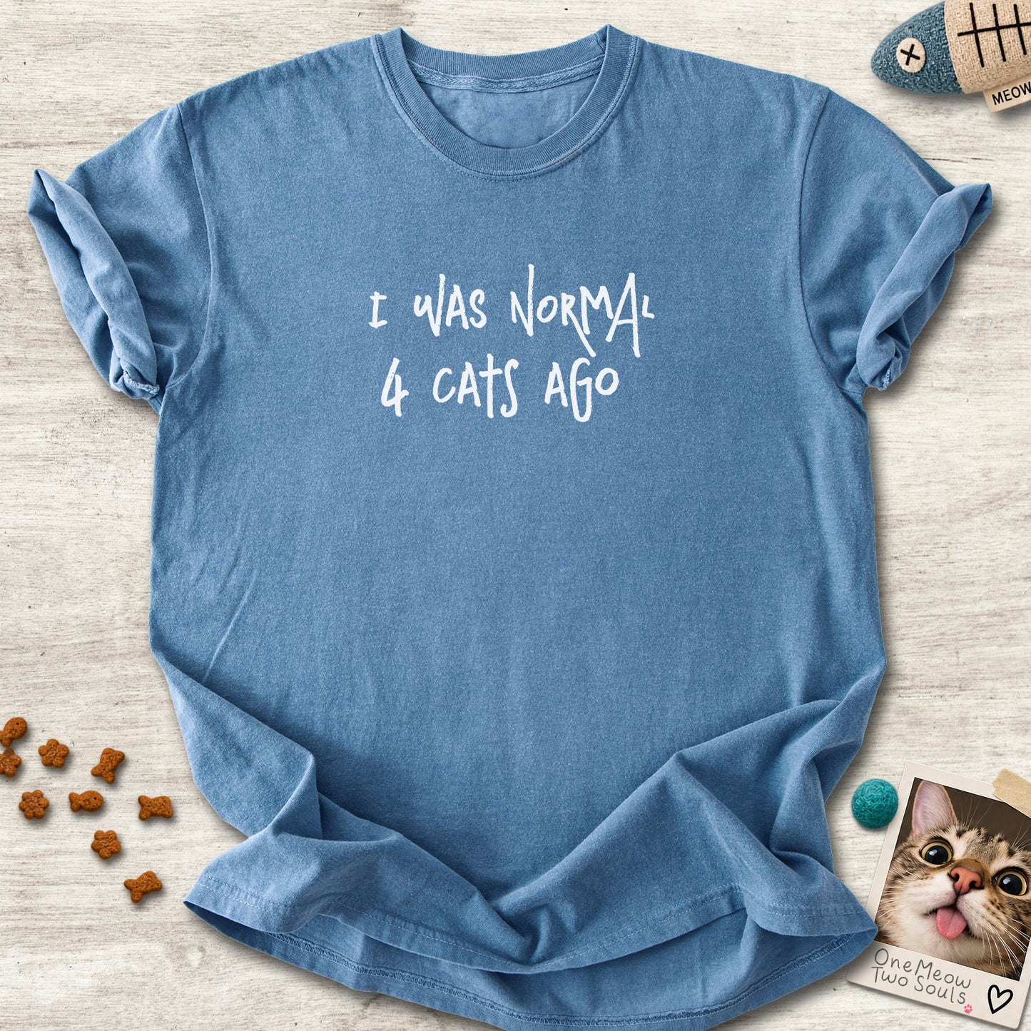 Blue jean colored Comfort Colors 1717 cotton T-shirt, featuring a "I was normal 4 cats ago" funny cat design illustration. One Meow Two Souls brand.