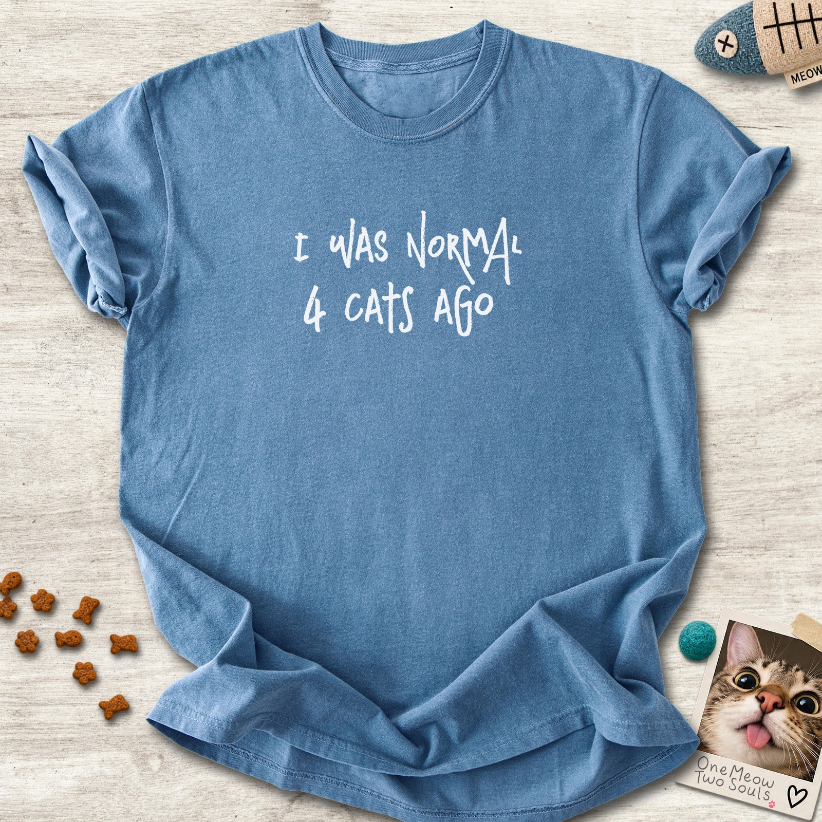 Blue jean colored Comfort Colors 1717 cotton T-shirt, featuring a "I was normal 4 cats ago" funny cat design illustration. One Meow Two Souls brand.