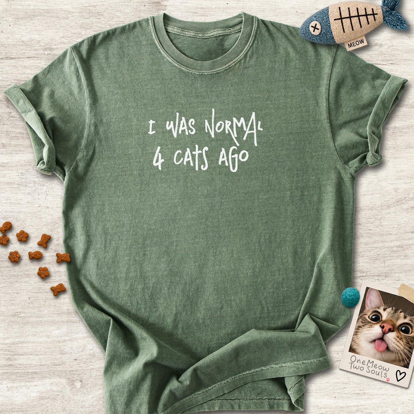 Moss colored Comfort Colors 1717 cotton T-shirt, featuring a "I was normal 4 cats ago" funny cat design illustration. One Meow Two Souls brand.