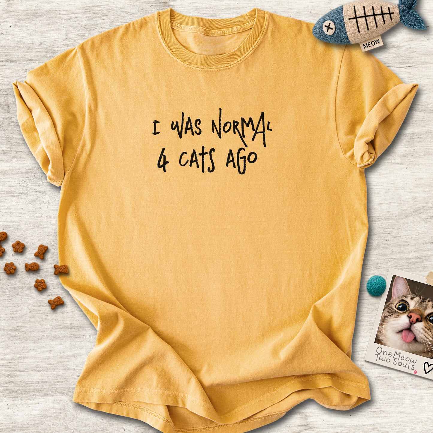 Mustard colored Comfort Colors 1717 cotton T-shirt, featuring a "I was normal 4 cats ago" funny cat design illustration. One Meow Two Souls brand.