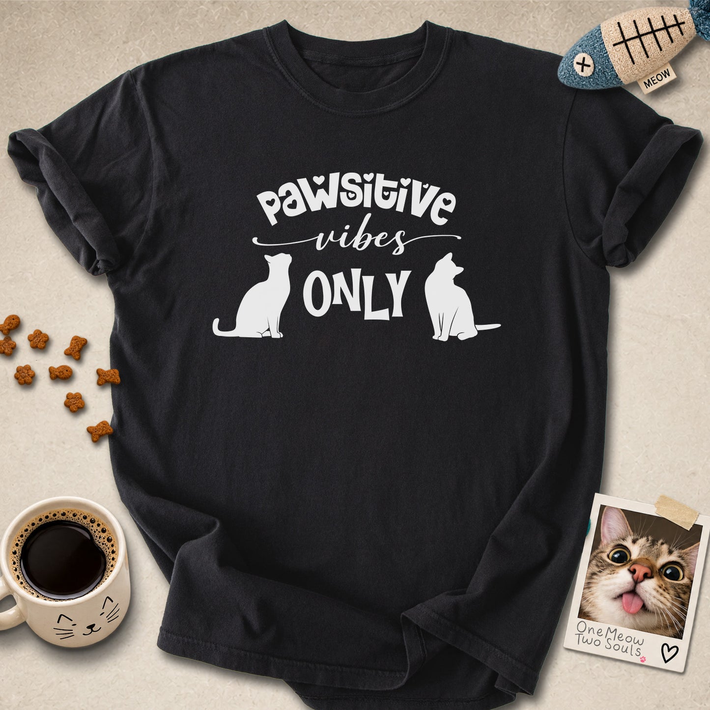 Black colored Comfort Colors 1717 cotton T-shirt, featuring a "Pawsitive Vibes Only" funny cat design illustration. One Meow Two Souls brand.