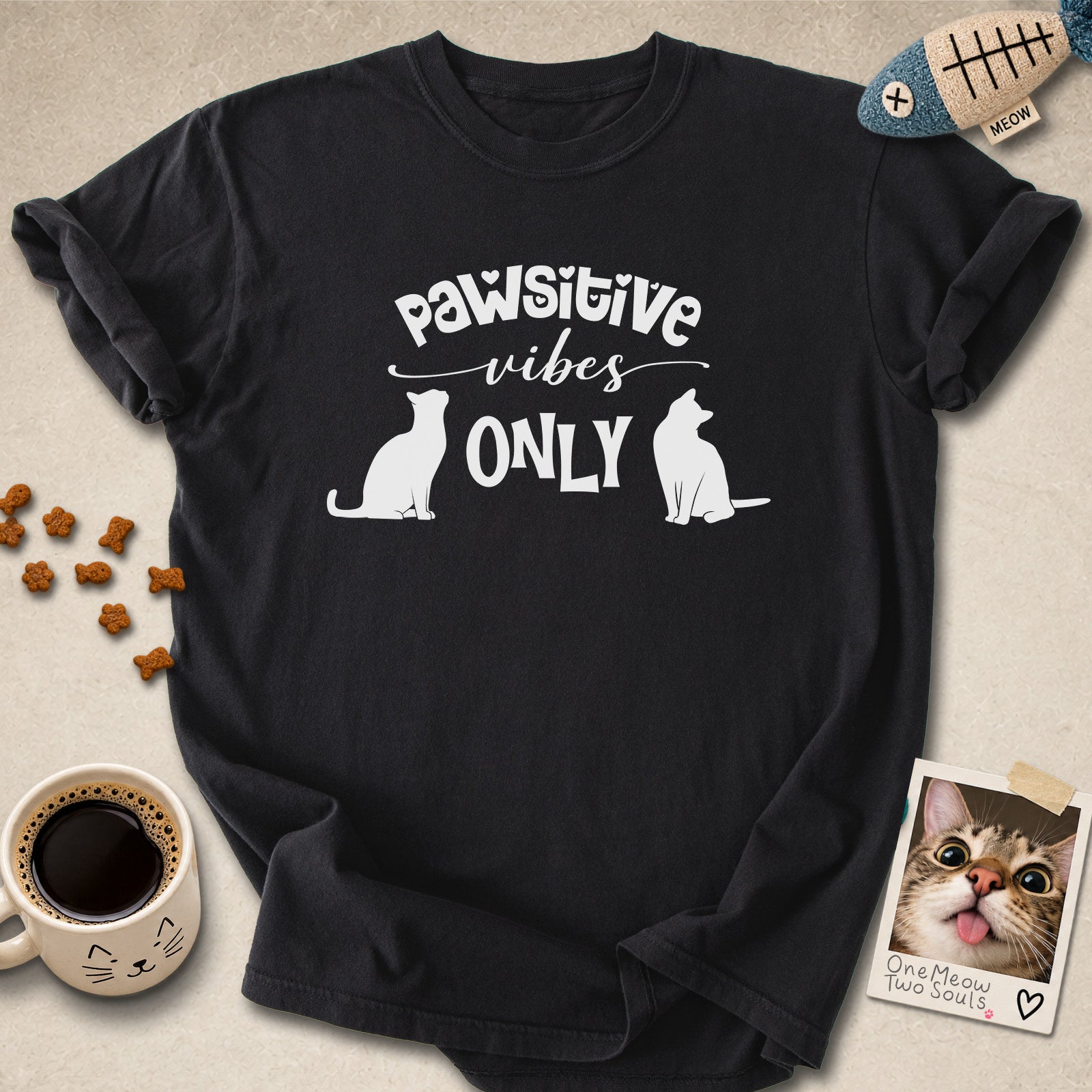 Black colored Comfort Colors 1717 cotton T-shirt, featuring a "Pawsitive Vibes Only" funny cat design illustration. One Meow Two Souls brand.
