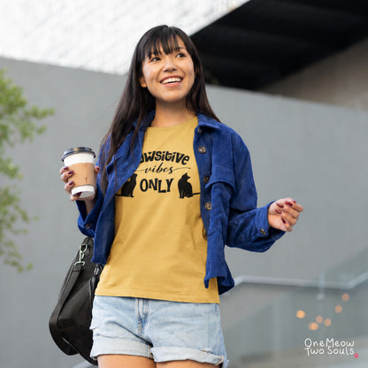 Mustard colored Comfort Colors 1717 cotton T-shirt, featuring a "Pawsitive Vibes Only" funny cat design illustration. One Meow Two Souls brand.