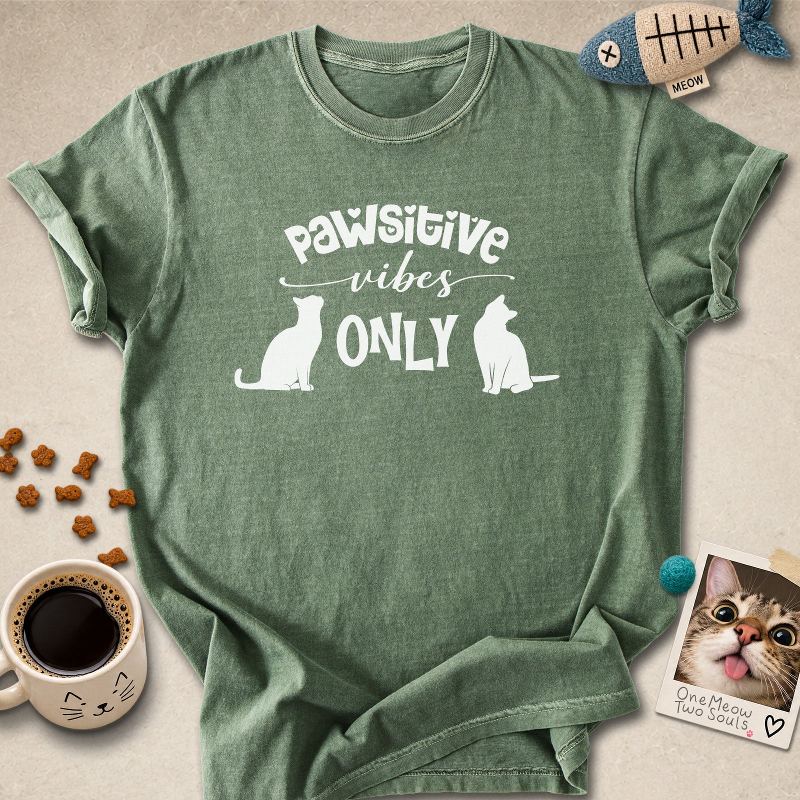 Moss colored Comfort Colors 1717 cotton T-shirt, featuring a "Pawsitive Vibes Only" funny cat design illustration. One Meow Two Souls brand.