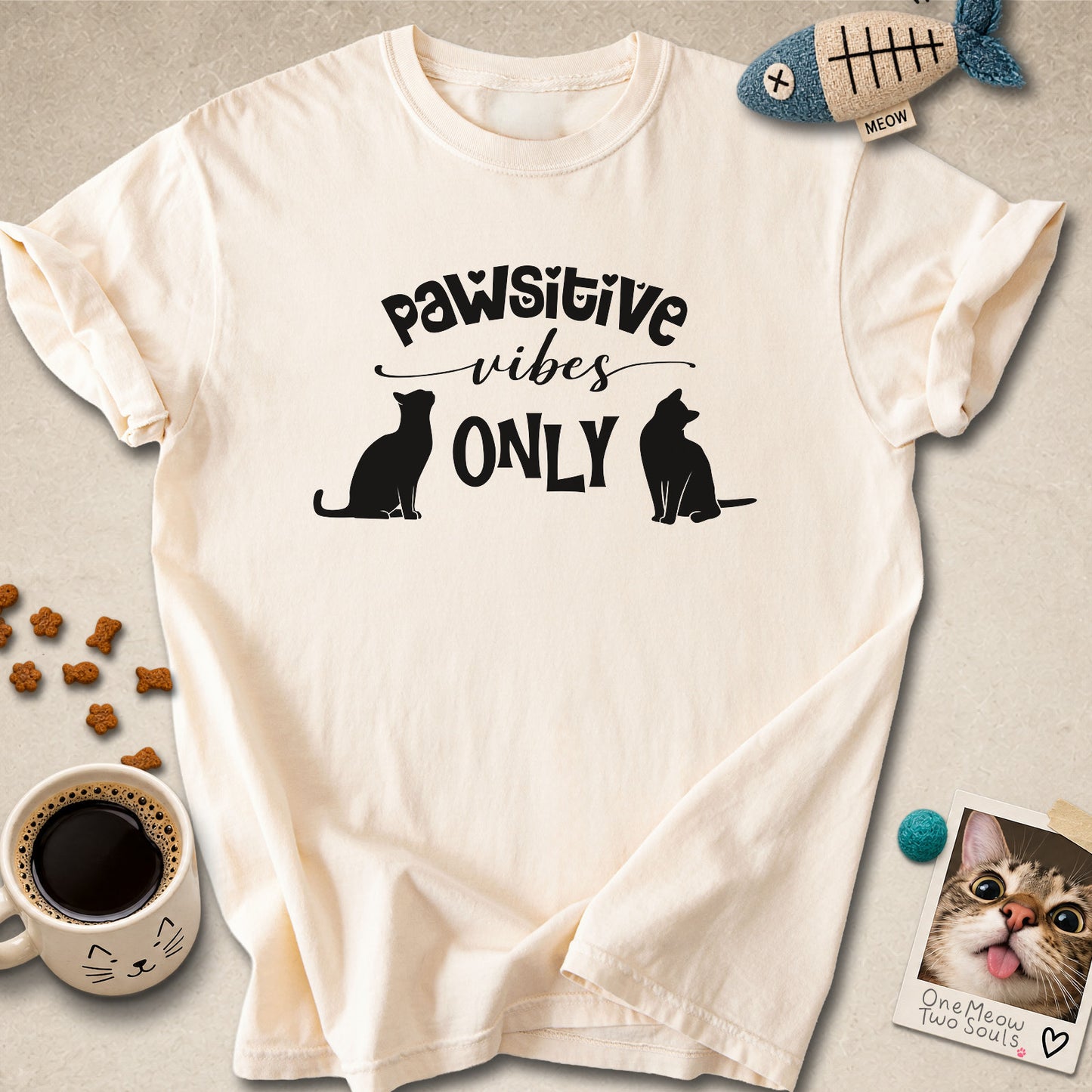 Ivory colored Comfort Colors 1717 cotton T-shirt, featuring a "Pawsitive Vibes Only" funny cat design illustration. One Meow Two Souls brand.
