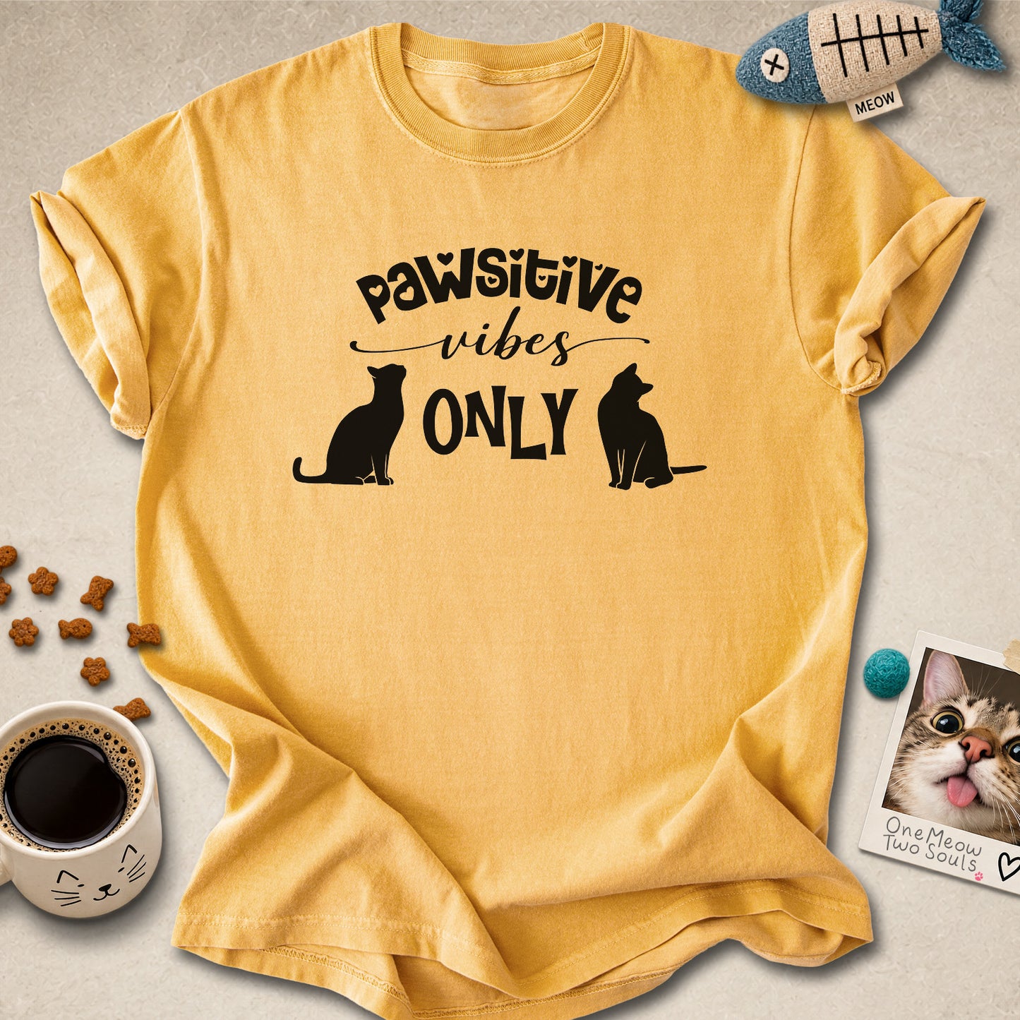 Mustard colored Comfort Colors 1717 cotton T-shirt, featuring a "Pawsitive Vibes Only" funny cat design illustration. One Meow Two Souls brand.