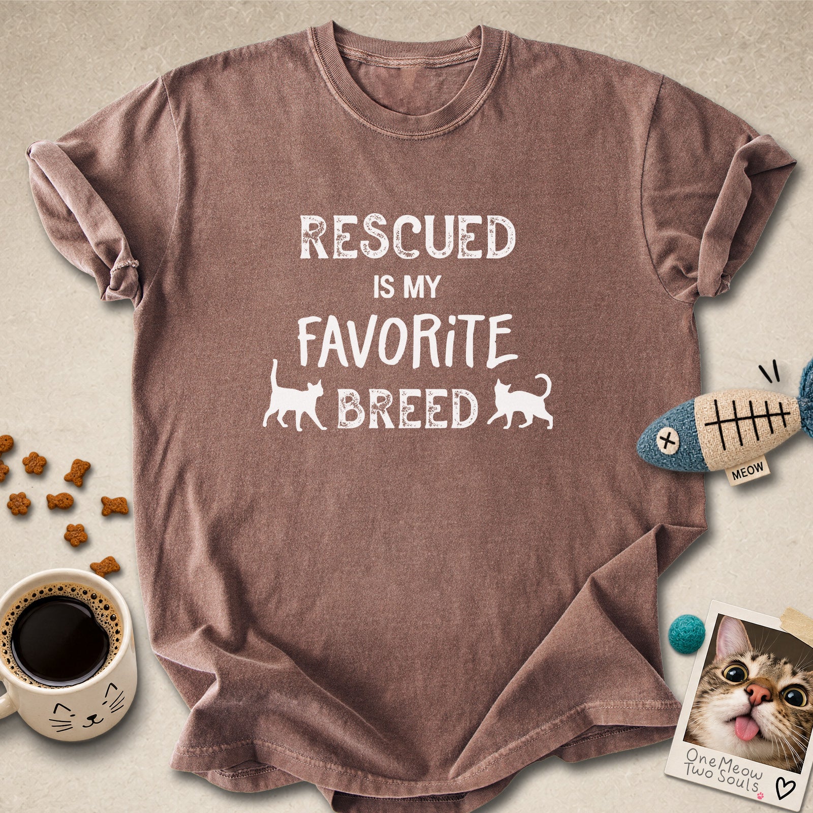 Espresso colored Comfort Colors 1717 cotton T-shirt, featuring a "Rescued is my favorite breed" funny cat design. One Meow Two Souls brand.