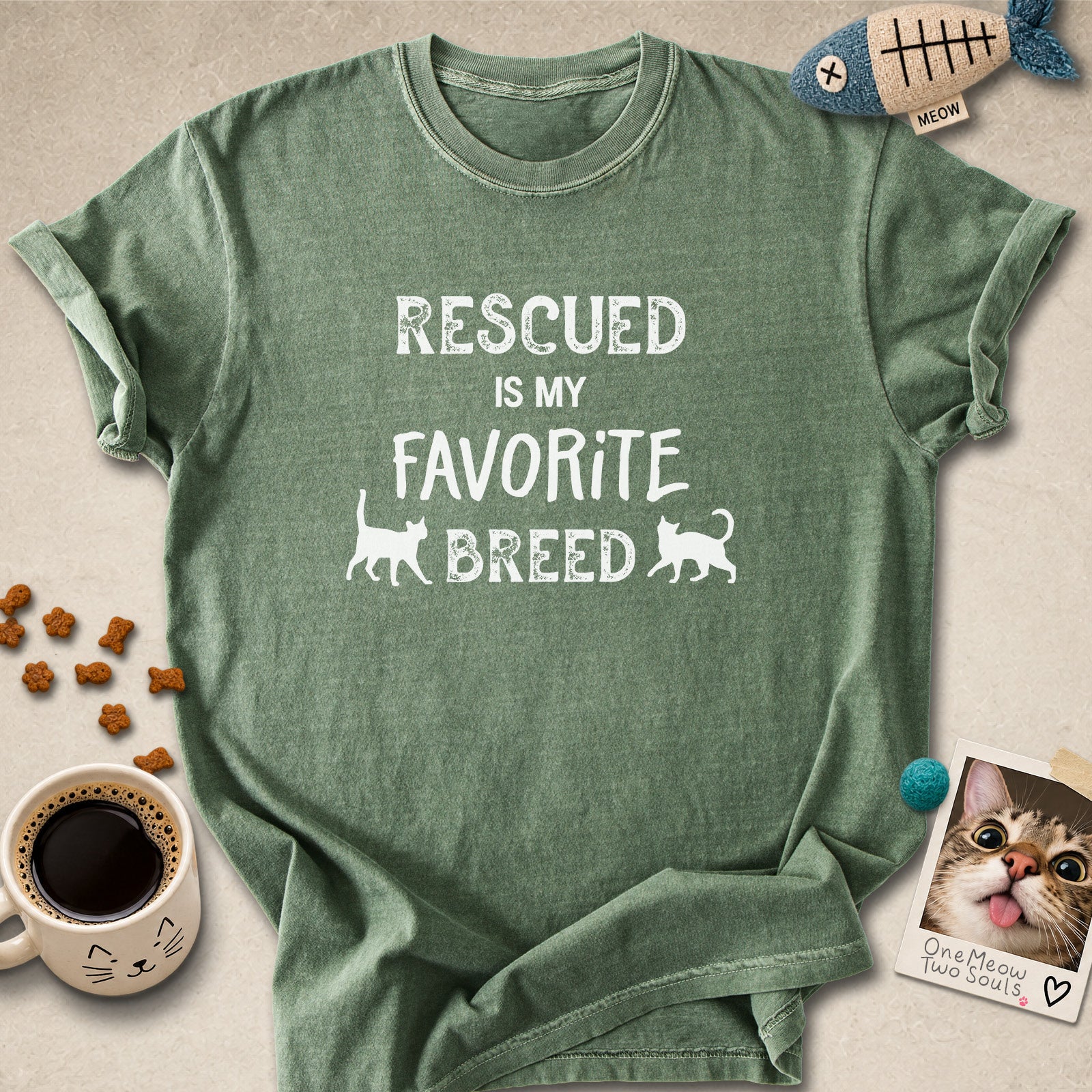 Moss colored Comfort Colors 1717 cotton T-shirt, featuring a "Rescued is my favorite breed" funny cat design. One Meow Two Souls brand.