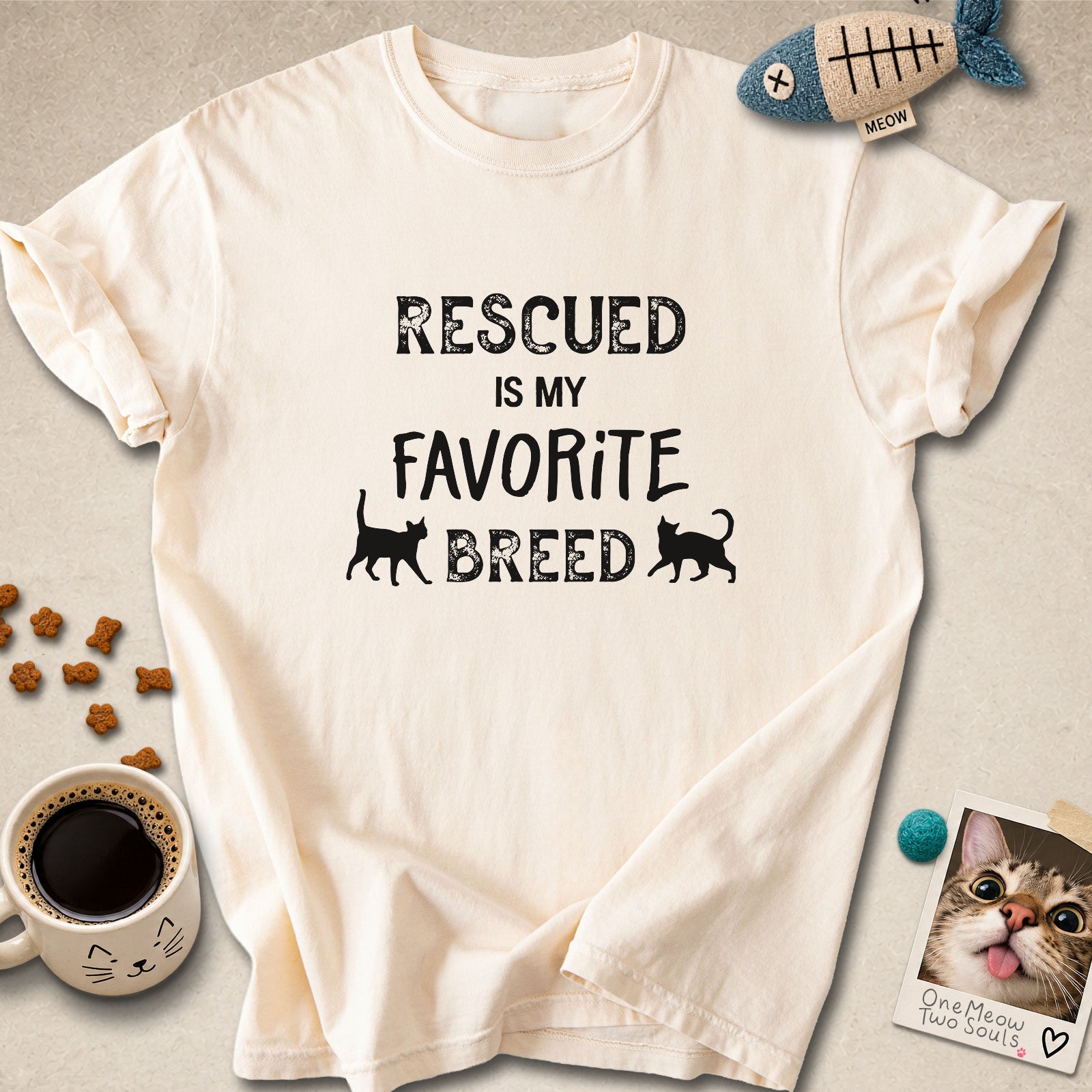 Ivory colored Comfort Colors 1717 cotton T-shirt, featuring a "Rescued is my favorite breed" funny cat design. One Meow Two Souls brand.