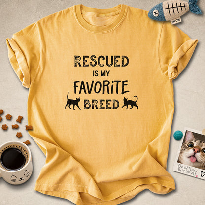 Mustard colored Comfort Colors 1717 cotton T-shirt, featuring a "Rescued is my favorite breed" funny cat design. One Meow Two Souls brand.