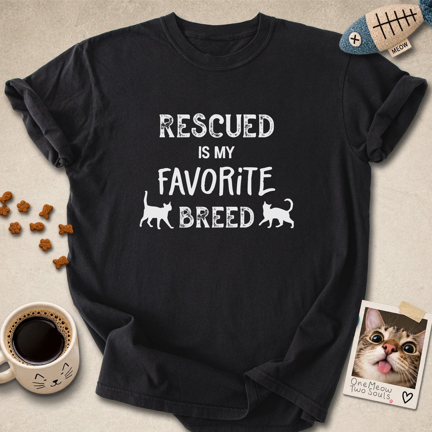 Black colored Comfort Colors 1717 cotton T-shirt, featuring a "Rescued is my favorite breed" funny cat design. One Meow Two Souls brand.