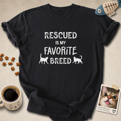 Black colored Comfort Colors 1717 cotton T-shirt, featuring a "Rescued is my favorite breed" funny cat design. One Meow Two Souls brand.