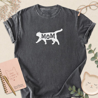 Pepper color Comfort Colors 1717 short-sleeve t-shirt with a white cat silhouette and the word 'MOM' across the chest. One Meow Two Souls brand.