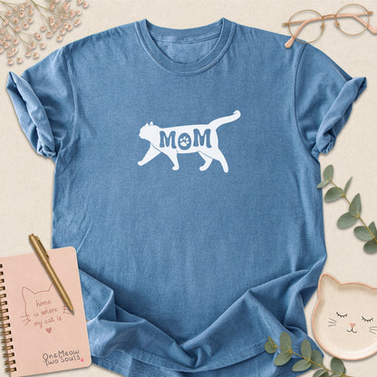 Blue Jean color Comfort Colors 1717 short-sleeve t-shirt with a white cat silhouette and the word 'MOM' across the chest. One Meow Two Souls brand.